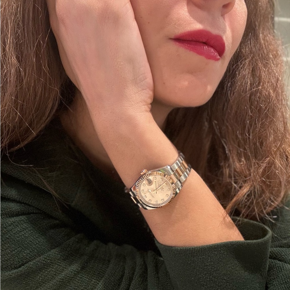 Rose Gold AUTHENTIC Rolex Watch with diamonds on the inside.